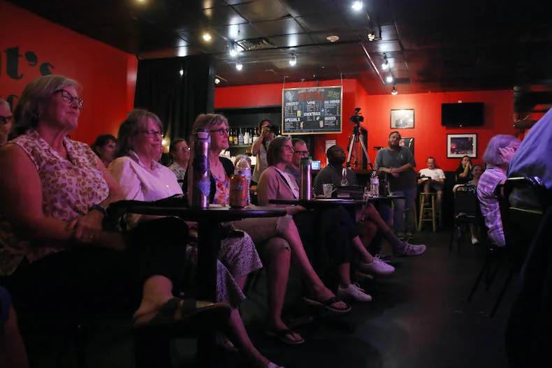 Attendees of the Alliance for a Healthy Kansas "One Nation, Overcharged" event enjoy an improv comedy show at Clint's Comedy Club in Overland Park.