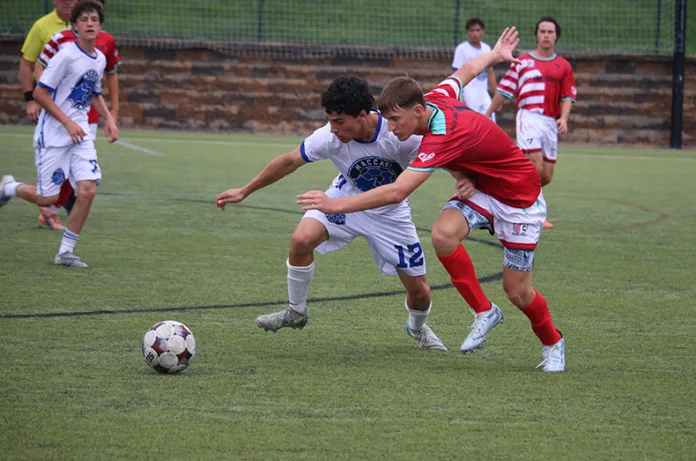 From left, Aaron Weiss and Nadav Silberstein compete for the ball during the bronze medal soccer game.
