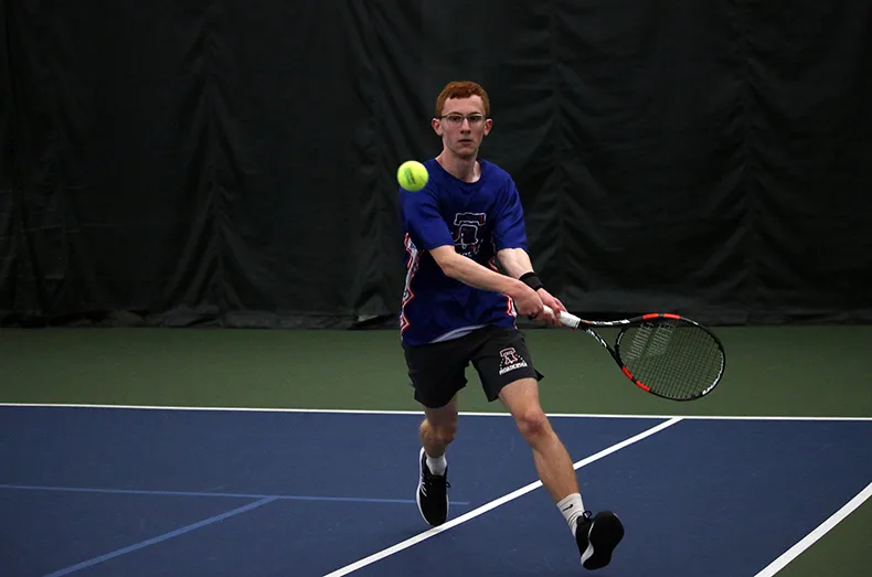 Philadelphia's Ethan Swichar runs to hit the ball during a tennis match.