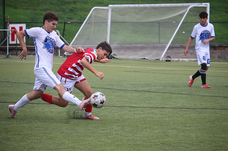 From left, Max Moore kicks the ball as Max Atlas tries to intercept it during the bronze medal soccer game. Both played on combined teams, Moore for St. Louis, Seattle, Long Island, Minnesota, Westchester and Chicago and Atlas for Jacksonville, Kansas City, Florida Gulf Coast, San Diego, the Carolinas and Philadelphia.