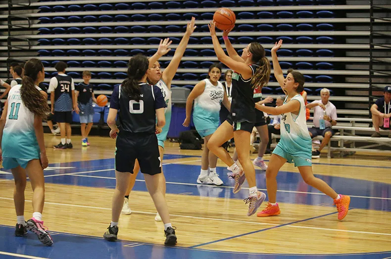 Sabra Bergh (center) aims at the basket as members of the Jersey Shore team move to block her. Bergh was part of a combined team that included players from Kansas City, San Diego, San Francisco and Memphis.