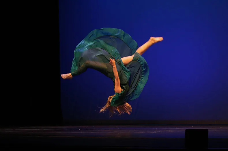 Kansas City team member Logan Nicholls flips during her solo dance performance.