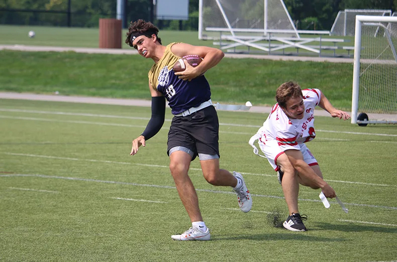 From left, during a flag football game, Tony Erlich of Denver loses one of his flags to Kansas City's Dylan Freiden.
