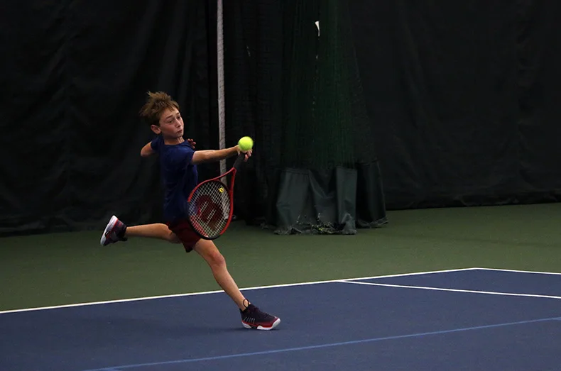 Kansas City's Theo Buchbinder reaches for the ball during a tennis match.