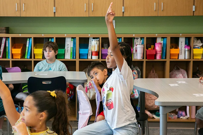 A Pawnee third grader raises her hand to answer a question on the first day of school in 2026. Photo credit Juliana Garcia.