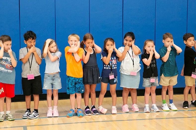 For their first day back, Pawnee Panthers spent their specials hour in the gym. Some, like the first graders pictured above, played Simon Says. Photo credit Juliana Garcia.