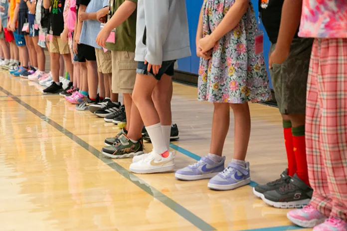 Shawnee Mission elementary student line up in a gym. Photo credit Juliana Garcia.