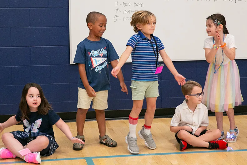 In the gym at Pawnee Elementary on Aug. 12, students played games like Simon Says for the first day of school. Above, first graders enjoy the game. Photo credit Juliana Garcia.