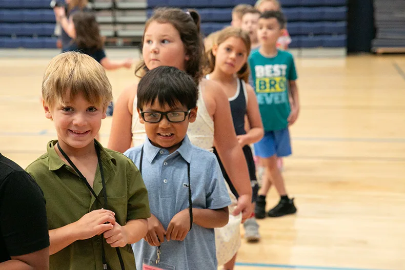 First grade students line up to return to their classroom after playing Simon Says on the first day of school. Photo credit Juliana Garcia.