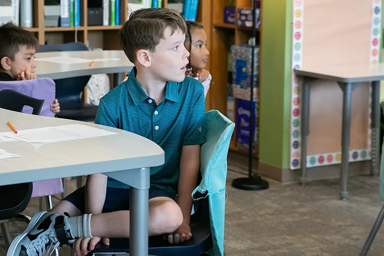A third grade boy awaits further instructions from his teacher on the first day back in 2026. Photo credit Juliana Garcia.