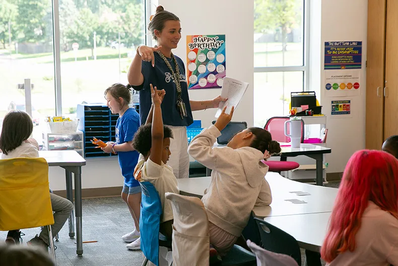 Teachers and students are falling back into school procedures at Pawnee Elementary. Above, a third grade teacher points out a student who is using Pawnee's hand signal for listening ears. Photo credit Juliana Garcia.