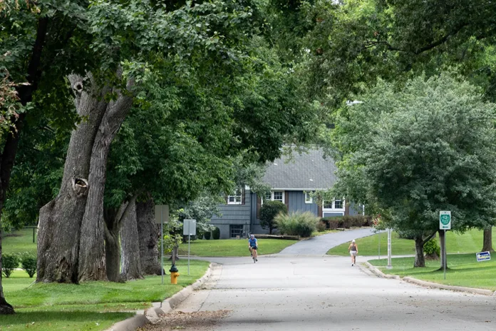 People bike and walk near the corner of Mohawk Ln and W 101st in Leawood on Sunday afternoon.