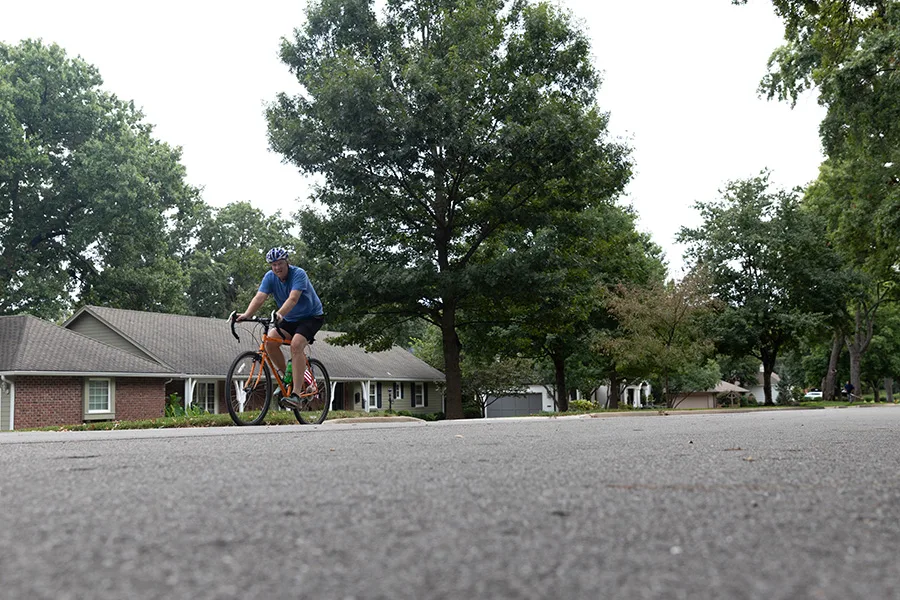 A man rides his bike North down Mohawk Lane in between 101st Street and 97th Place in Leawood on Sunday afternoon.