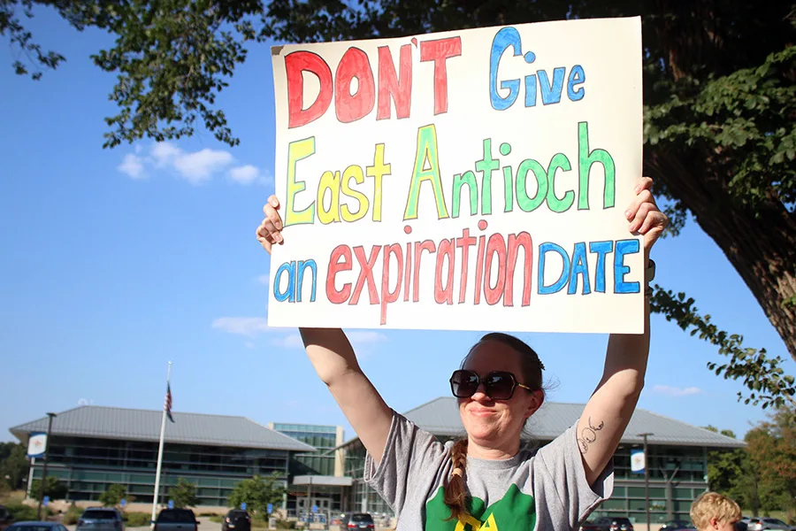 Jeneice Waters, parent of an East Antioch second-grader, shows her support for the school during a rally Sept. 1.