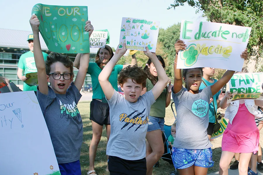 From left, Jackson Cooper, 10, Will Cardin, 9, and Presley Carr, 9, participate in a Sept. 1 rally protesting their school's possible closure.