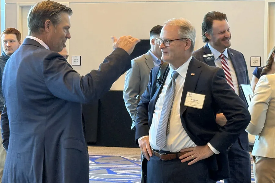 Kobach (left) chats with Democratic U.S. Senate candidate Adam Hamilton before an Olathe event talking to business leaders.