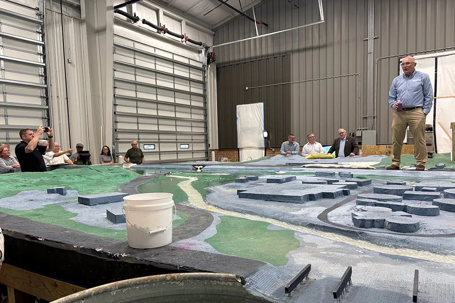 Don Baker of Water Resource Solutions (right) demonstrates a 3-D flood model on March 30 at a city maintenance facility.