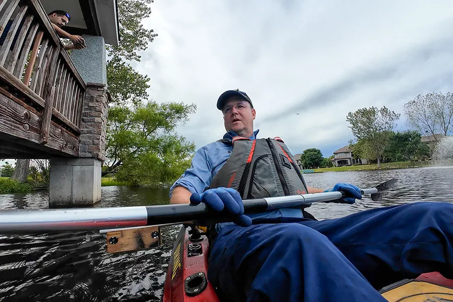 James Hinkle, founder of Echo Divers, takes a kayak into the pond in Leawood.