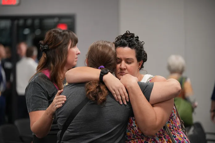 Scarborough Elementary parent and substitute teacher Valerie Volker (right) hugs Scarborough Fourth Grade Teacher Debbie Jones following Thursday night’s announcement that named Scarborough as recommended for closure.
