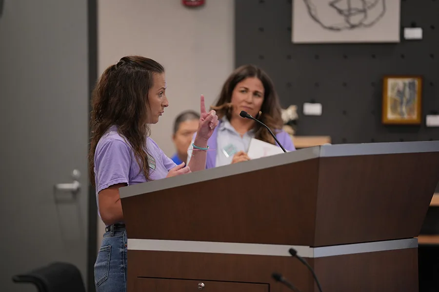 Prairie Elementary parent Jennifer Varon speaks to the board of education during public comment, urging them to better consider how boundary changes will affect students. "This proposal is easy on paper, and it's hard on the kids," she said.