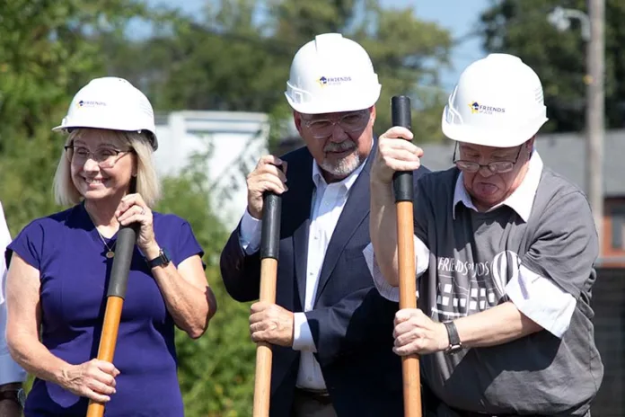 Community members and local officials break ground on the new Friends of JCDS apartment building in downtown Overland Park.