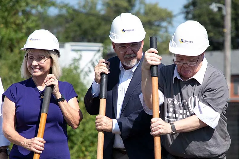 Community members and local officials break ground on the new Friends of JCDS apartment building in downtown Overland Park.