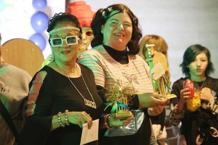 From left, Joanna Marin and Kirsten Dyson show off their trophies from the costume contest at Mission's 75th anniversary celebration.
