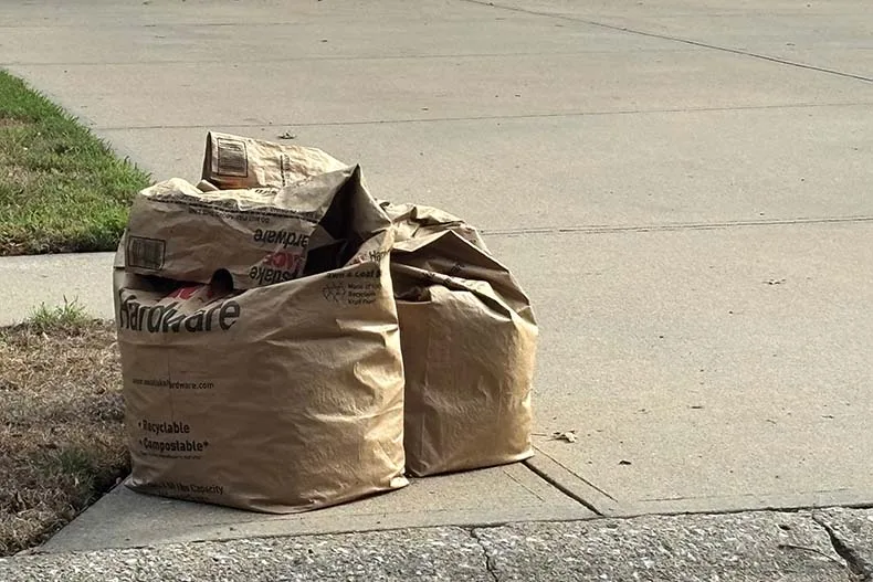 Yard waste bags sit near the curb for trash pickup day in a northern Overland Park neighborhood.