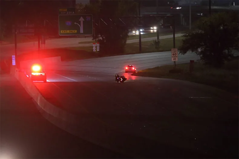 A view of a the motorcycle involved in the crash on its side in the center lane of the highway. Photo credit Mike Frizzell. 