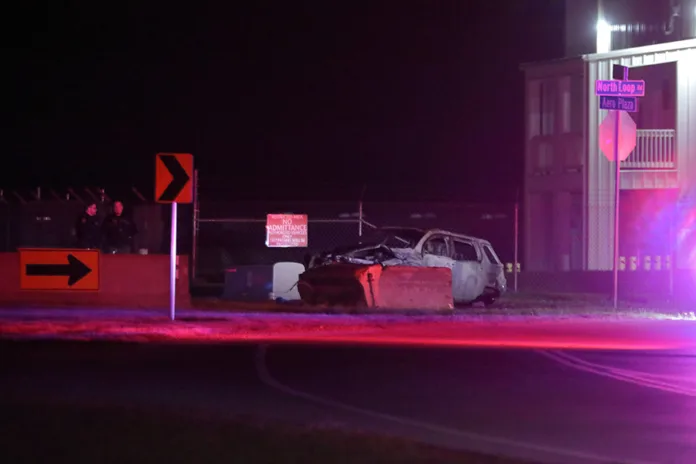 The crashed and burned vehicle at the scene.