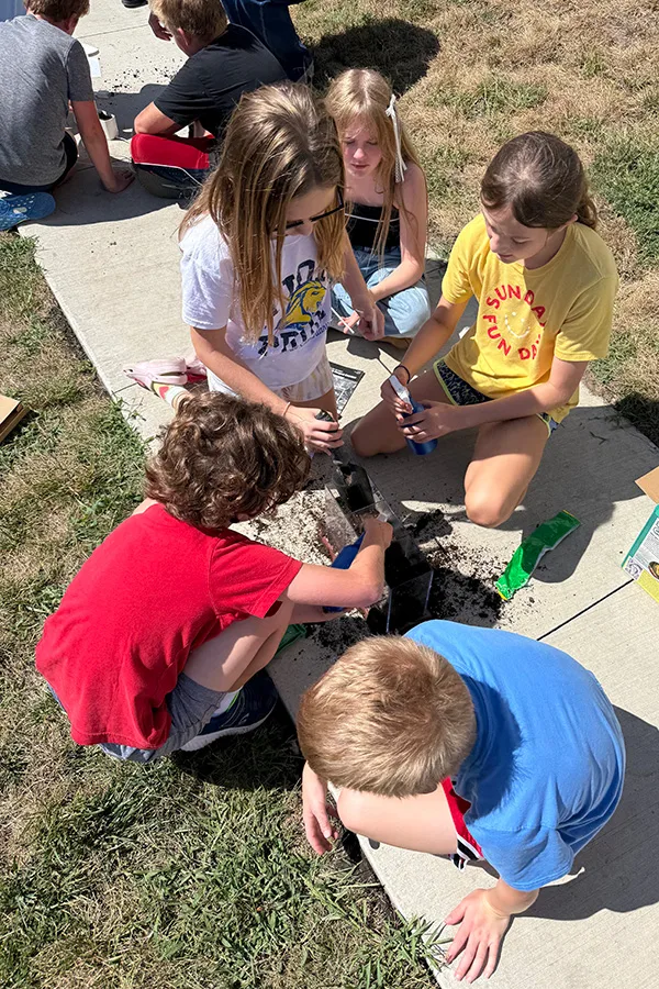 Students from April Cremer's class at Tomahawk Elementary work together to plant their seeds for the Willie and the Salad Bonanza program.