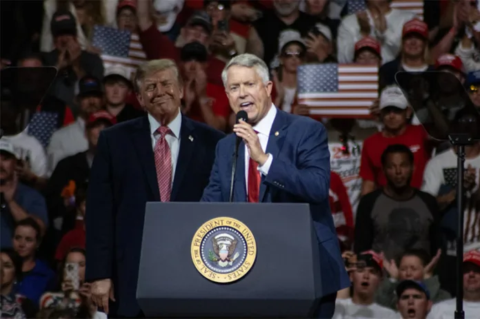 Sen. Roger Marshall speaks as President Trump looks on. Photo credit Roger Nomer/Kansas News Service.