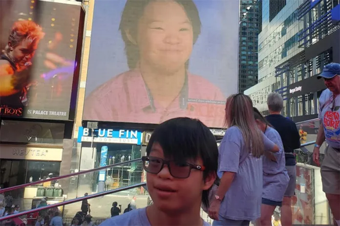 Wil Sykes, a Blue Valley Northwest freshman, in Times Square on Sept. 12 celebrating his photo appearing on two jumbotrons ahead of the National Down Syndrome Society's Annual Buddy Walk to Central Park. Photo courtesy Kim Sykes.